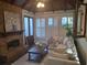 Sunroom with brick fireplace, wooden beams, and comfy seating area at 3463 Lee St, Smyrna, GA 30080