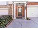 Townhouse entry with brick facade, dark brown door and white columns at 406 Patina Se Pl # 23, Mableton, GA 30126