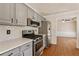 Modern kitchen with stainless steel appliances and gray cabinets at 1635 Glenfield Dr, Lawrenceville, GA 30043