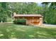 House exterior with green lawn and wooded backdrop at 3454 Hill Ln, Acworth, GA 30102