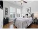 Bright bedroom with hardwood floors and plantation shutters at 360 Chambers St # 310, Woodstock, GA 30188