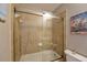 Full bathroom with glass shower doors, bathtub, decorative tile and toilet at 2782 Loftview Sq # 1, Atlanta, GA 30339