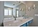 Bathroom features a quartz countertop, blue vanity, and large mirror at 2782 Loftview Sq # 1, Atlanta, GA 30339