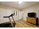 Functional room with wood floors, TV on wooden stand, fitness machine, and closet for storage at 2782 Loftview Sq # 1, Atlanta, GA 30339