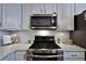 Stainless steel range and microwave complement the white kitchen cabinetry at 2782 Loftview Sq # 1, Atlanta, GA 30339