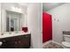 Bathroom featuring a single sink vanity with granite countertop and a shower with a red curtain at 9475 Dunmoore Dr, Cumming, GA 30028