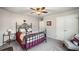 Cozy bedroom with a decorative iron bed frame, neutral walls, and a ceiling fan at 9475 Dunmoore Dr, Cumming, GA 30028