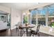 Bright dining area with hardwood floors, large windows, and elegant lighting at 9475 Dunmoore Dr, Cumming, GA 30028