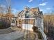 Attractive exterior with stone accents, a driveway, and a covered front porch at 9475 Dunmoore Dr, Cumming, GA 30028