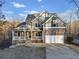 Inviting two-story home with stone accents, a well-manicured lawn, and attached two car garage at 9475 Dunmoore Dr, Cumming, GA 30028