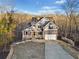 Charming two-story home with a stone facade, inviting porch, and well-manicured lawn at 9475 Dunmoore Dr, Cumming, GA 30028