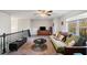 Inviting living room area featuring a futon, flat screen TV, and view of the outdoors at 9475 Dunmoore Dr, Cumming, GA 30028
