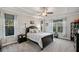 Spacious main bedroom with a tray ceiling, carpeted floors and large windows overlooking the yard at 9475 Dunmoore Dr, Cumming, GA 30028