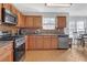 Kitchen with wood cabinets, granite countertops, and stainless steel appliances at 220 Baltimore Ave, Stockbridge, GA 30281