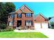 Brick two-story house with a two car garage and landscaping at 3854 Heritage Crest Pkwy, Buford, GA 30519