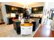 Modern kitchen with dark cabinetry, granite countertops, and an island at 3854 Heritage Crest Pkwy, Buford, GA 30519