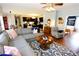 Open concept living room with hardwood floors, sectional sofa, and view of kitchen at 3854 Heritage Crest Pkwy, Buford, GA 30519