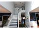 Two-story foyer with a dramatic, black and white staircase at 3854 Heritage Crest Pkwy, Buford, GA 30519