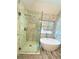 Bathroom featuring a glass shower, freestanding tub, tile flooring, and window at 5619 Mayfair Crossing Dr, Lithonia, GA 30038