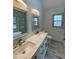 Bathroom featuring dual sinks, tile flooring, a toilet, and two mirrors at 5619 Mayfair Crossing Dr, Lithonia, GA 30038