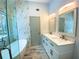 Bright bathroom with a double vanity, soaking tub and walk-in shower with beautiful marble-look tile surround at 5619 Mayfair Crossing Dr, Lithonia, GA 30038