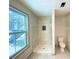 Bright bathroom featuring a new shower with elegant marble-look tile, shower niche, and sleek shower fixture at 5619 Mayfair Crossing Dr, Lithonia, GA 30038