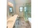 Bathroom featuring dual sinks, tile flooring, a glass shower, and a window at 5619 Mayfair Crossing Dr, Lithonia, GA 30038