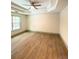 Bright bedroom features a ceiling fan, a tray ceiling, and a window at 5619 Mayfair Crossing Dr, Lithonia, GA 30038