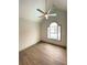 Spacious bedroom with high ceilings, large arched window and modern ceiling fan at 5619 Mayfair Crossing Dr, Lithonia, GA 30038