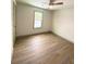 Cozy bedroom with wood-look flooring, neutral paint, and modern ceiling fan at 5619 Mayfair Crossing Dr, Lithonia, GA 30038