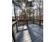 Gray wood deck with white railings is surrounded by mature trees and offers privacy at 5619 Mayfair Crossing Dr, Lithonia, GA 30038