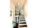 Inviting entryway with hardwood stairs and a stylish lighting fixture at 5619 Mayfair Crossing Dr, Lithonia, GA 30038