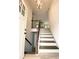 Spacious entryway with hardwood stairs and a modern lighting fixture at 5619 Mayfair Crossing Dr, Lithonia, GA 30038