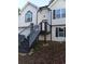 Close up exterior view of the home's entrance and modern stairway at 5619 Mayfair Crossing Dr, Lithonia, GA 30038