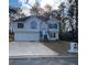 Charming split-level home with a two-car garage and inviting front entrance at 5619 Mayfair Crossing Dr, Lithonia, GA 30038