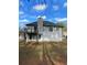 View of the home's back exterior featuring a deck and private backyard at 5619 Mayfair Crossing Dr, Lithonia, GA 30038