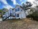 Side view of a two story home showcasing modern railing and backyard space at 5619 Mayfair Crossing Dr, Lithonia, GA 30038