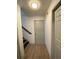Hallway with wood-look floors leads to rooms; a stairway to the left goes up a half flight at 5619 Mayfair Crossing Dr, Lithonia, GA 30038