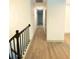 Hallway with wood floors leading to various rooms in the house at 5619 Mayfair Crossing Dr, Lithonia, GA 30038
