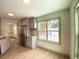 Bright eat-in kitchen featuring gray cabinets, stainless steel appliances, and a large window at 5619 Mayfair Crossing Dr, Lithonia, GA 30038