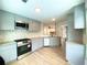 Well-equipped kitchen with gray cabinets, granite countertops and modern backsplash at 5619 Mayfair Crossing Dr, Lithonia, GA 30038