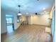 Spacious living room with hardwood floors, fireplace, and modern lighting fixtures at 5619 Mayfair Crossing Dr, Lithonia, GA 30038