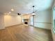 Bright living room featuring hardwood floors, a fireplace, and a modern ceiling fan at 5619 Mayfair Crossing Dr, Lithonia, GA 30038