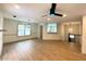 Open-concept living room with modern ceiling fan, hardwood floors, and lots of natural light at 5619 Mayfair Crossing Dr, Lithonia, GA 30038