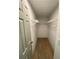 Functional walk-in closet with shelving and wood-look laminate flooring at 5619 Mayfair Crossing Dr, Lithonia, GA 30038