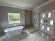 Modern bathroom with a large soaking tub and walk-in shower at 1534 Stargrass Dr, Grayson, GA 30017