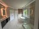 Luxurious bathroom with a soaking tub, glass shower, and marble floors at 1534 Stargrass Dr, Grayson, GA 30017