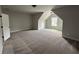 Spacious bedroom with carpeted floors and dormer windows at 1534 Stargrass Dr, Grayson, GA 30017