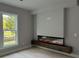 Gathering room with modern electric fireplace and wood mantel at 1534 Stargrass Dr, Grayson, GA 30017