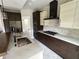 Modern kitchen with two-toned cabinets, marble countertops, and a gas range at 1534 Stargrass Dr, Grayson, GA 30017